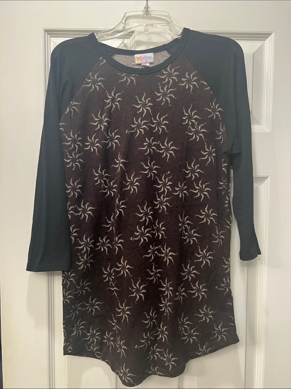 LuLaRoe Women's Black Raglan Top with Brown Starburst Print